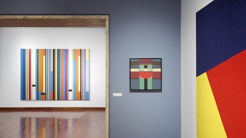 Installation view of an exhibition space showing three geometric pieces of art.